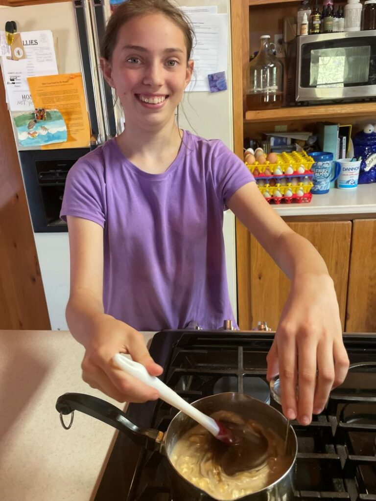 Madi making caramel apples